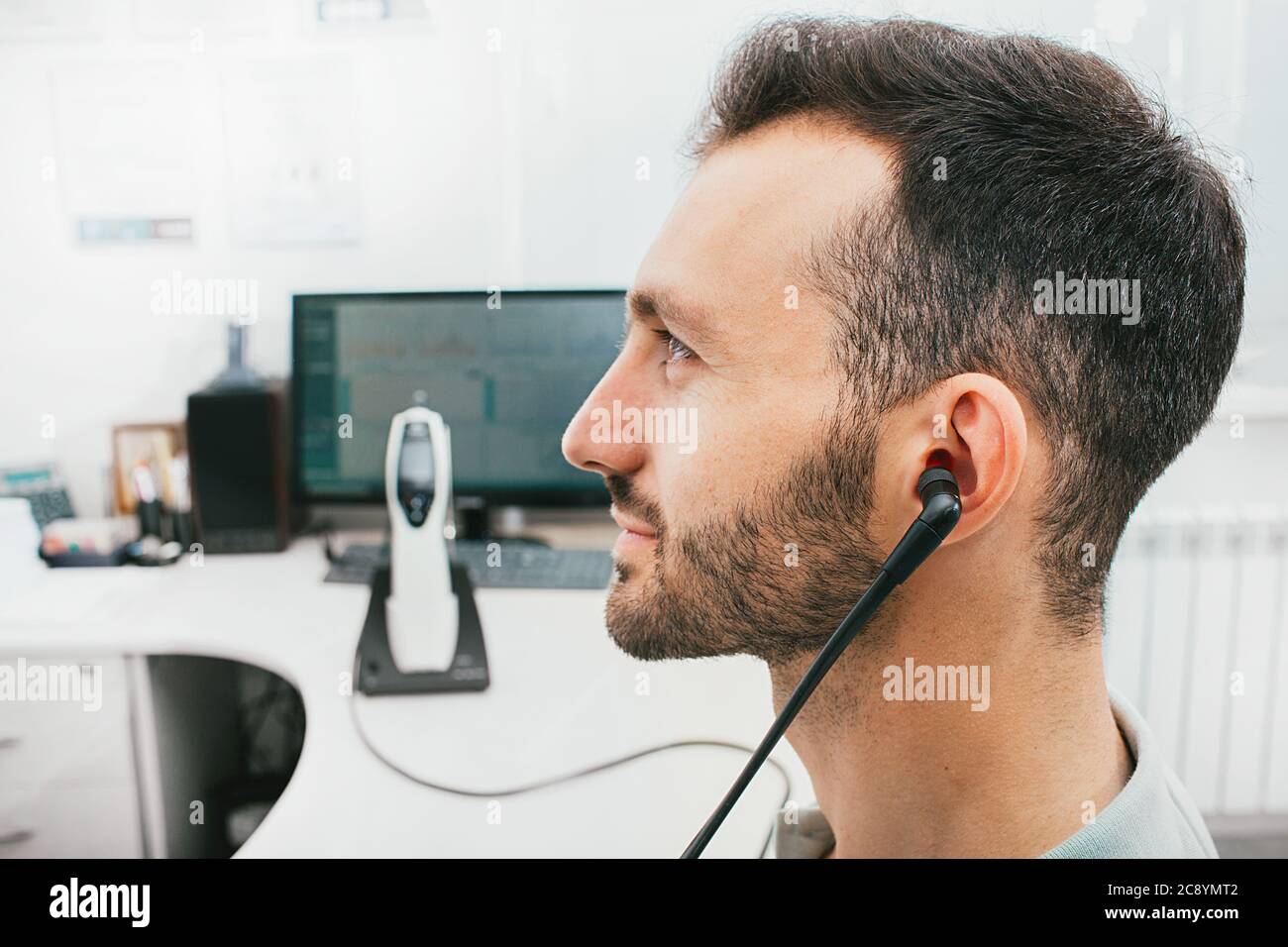 Diagnosis of hearing impairment, tympanometry, hearing test. A man during a hearing diagnostic