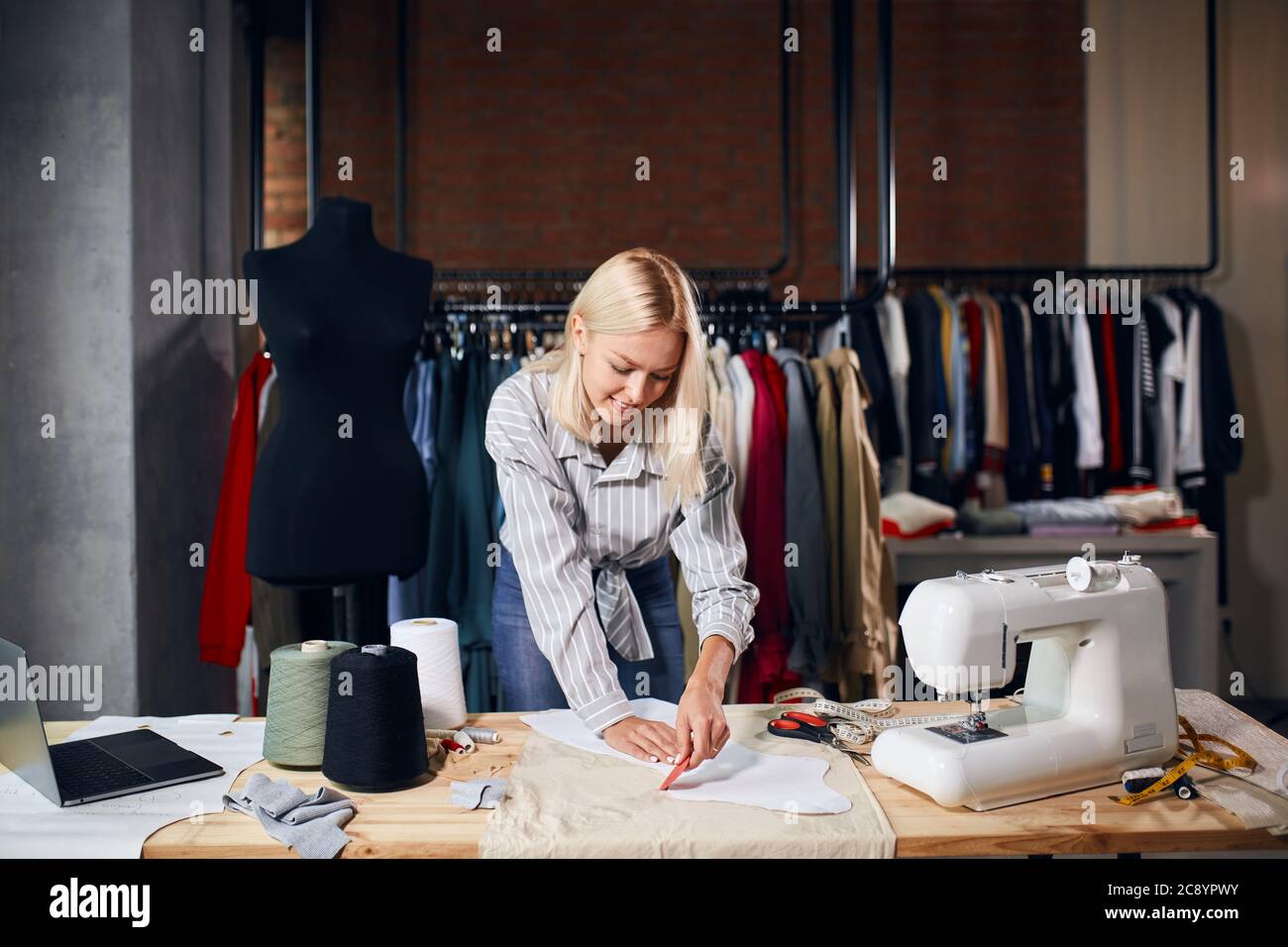 Blonde fashion designer drawing clothes hi-res stock photography and ...