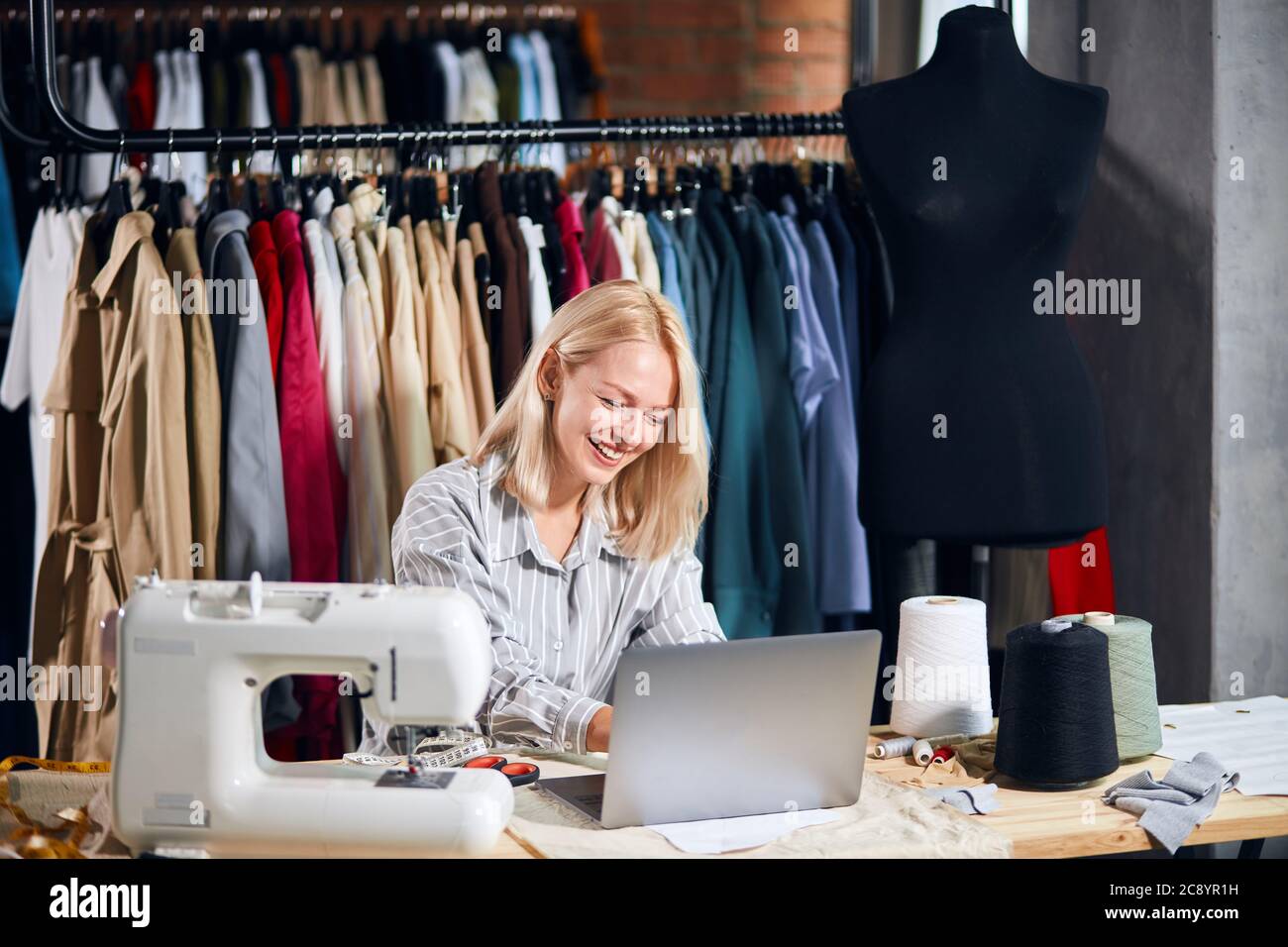 lazy tailor laughing, playing computer games at workplace. close up photo.  favourite pastime, hobby Stock Photo - Alamy