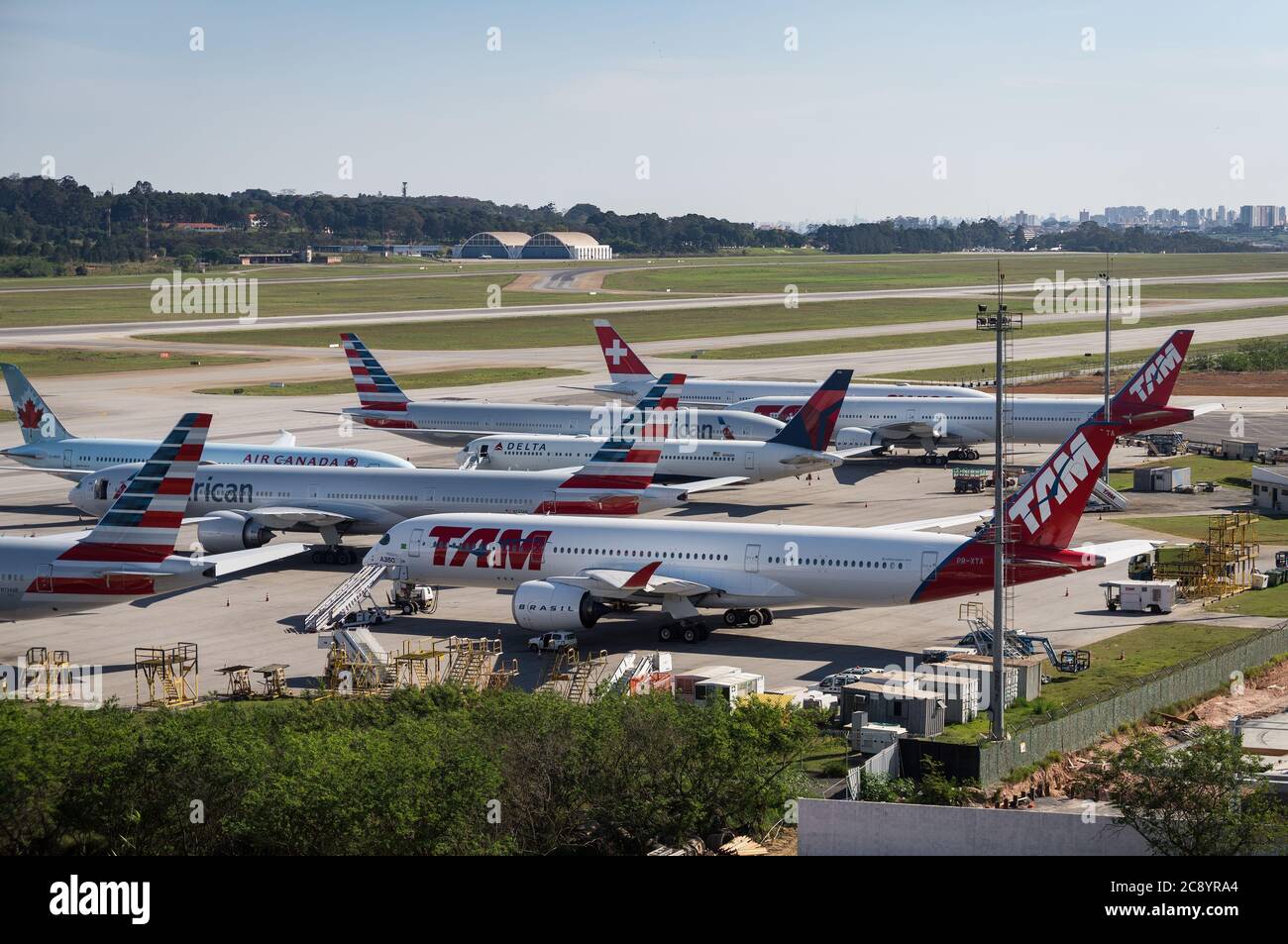 TAM Airlines Airbus A350 XWB (Long range wide-body aircraft - PR-XTA) parked with other airliners at the remote area of Guarulhos Intl. Airport. Stock Photo