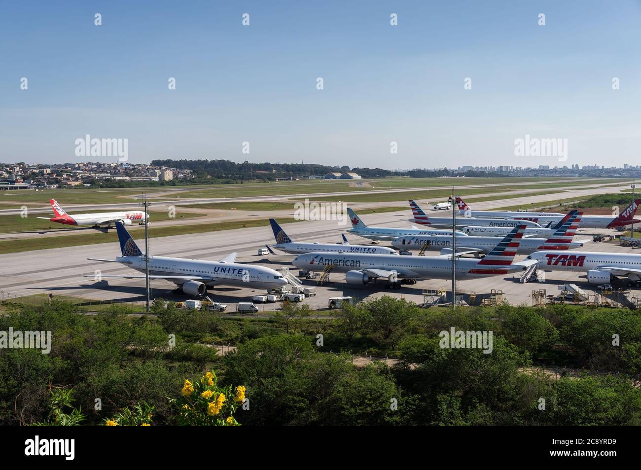Wide view of the remote aircraft parking area and partial view of main runways and taxiways of Guarulhos Intl. Airport. Morrinho spotting location. Stock Photo