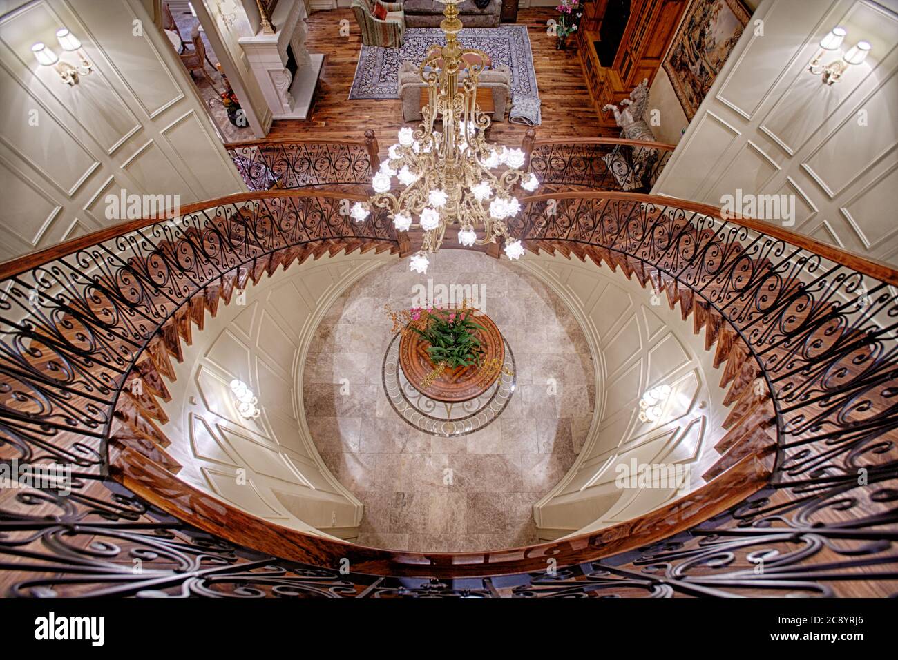 A Top Down View Of A Double Staircase In The Grand Entrance Of An Elegant Upscale Home With Chandilier Floor Medalion Wood Handrail And Wrought I Stock Photo Alamy