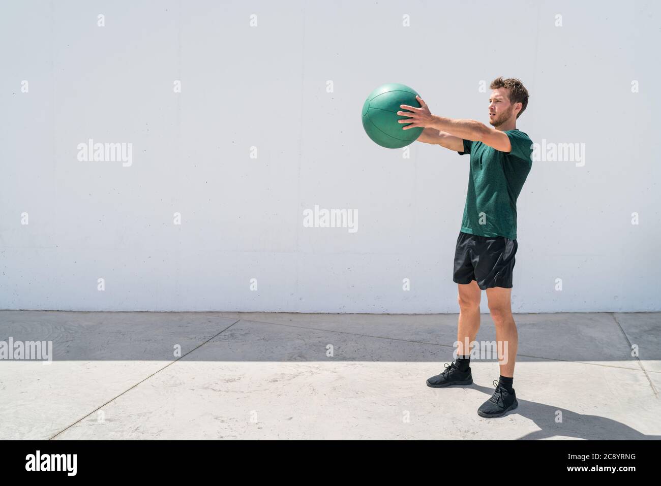 Medicine ball workout fitness man training arms Stock Photo Alamy