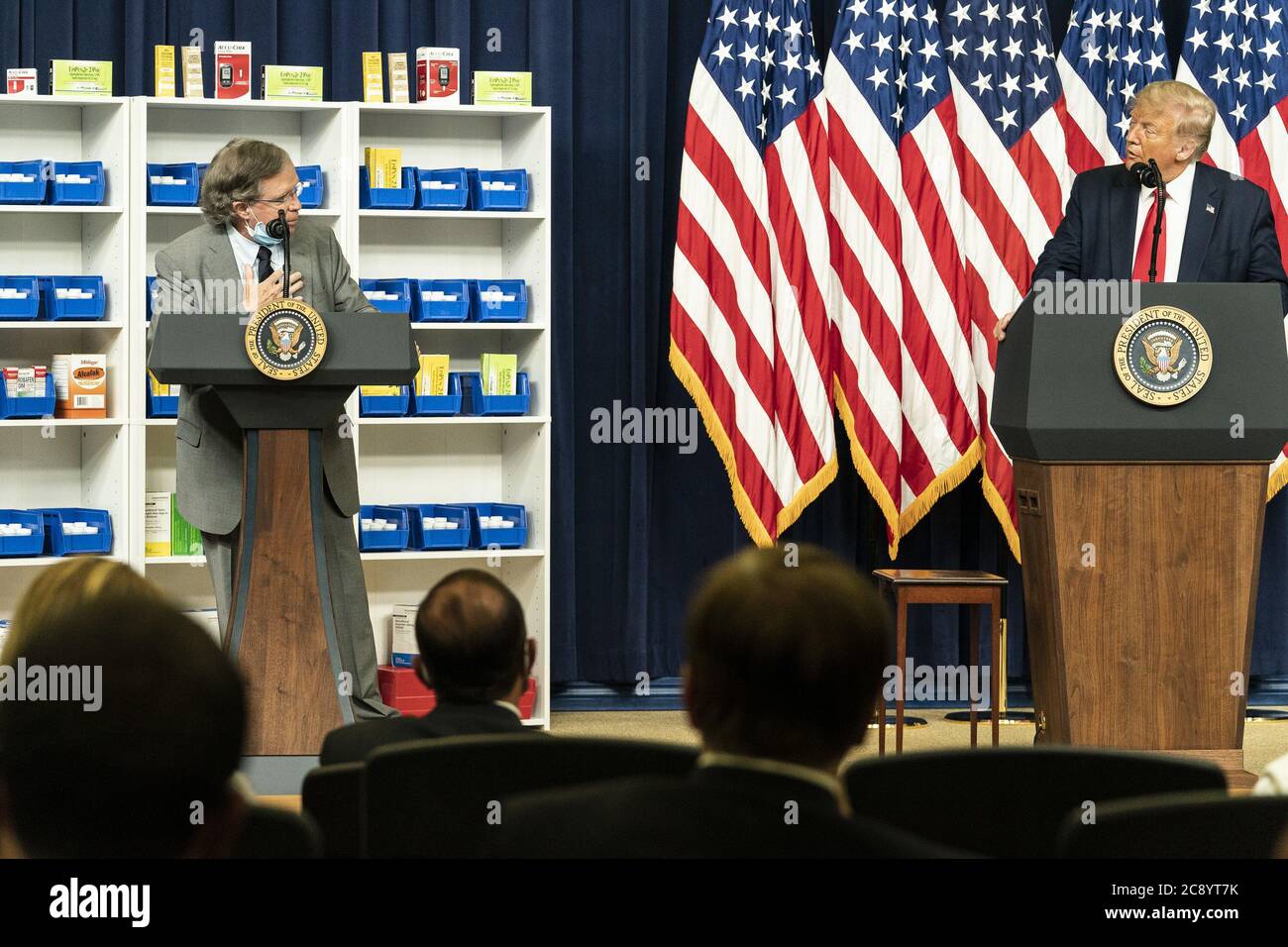 Washington, United States Of America. 24th July, 2020. President Donald J. Trump listens as guest Paul Madden, a diabetic who uses insulin, delivers remarks before the PresidentÕs signing of Executive Orders on Lowering Drug Prices Friday, July 24, 2020, in the South Court Auditorium of the Eisenhower Executive Office Building at the White House People: President Donald Trump, Paul Madden Credit: Storms Media Group/Alamy Live News Stock Photo
