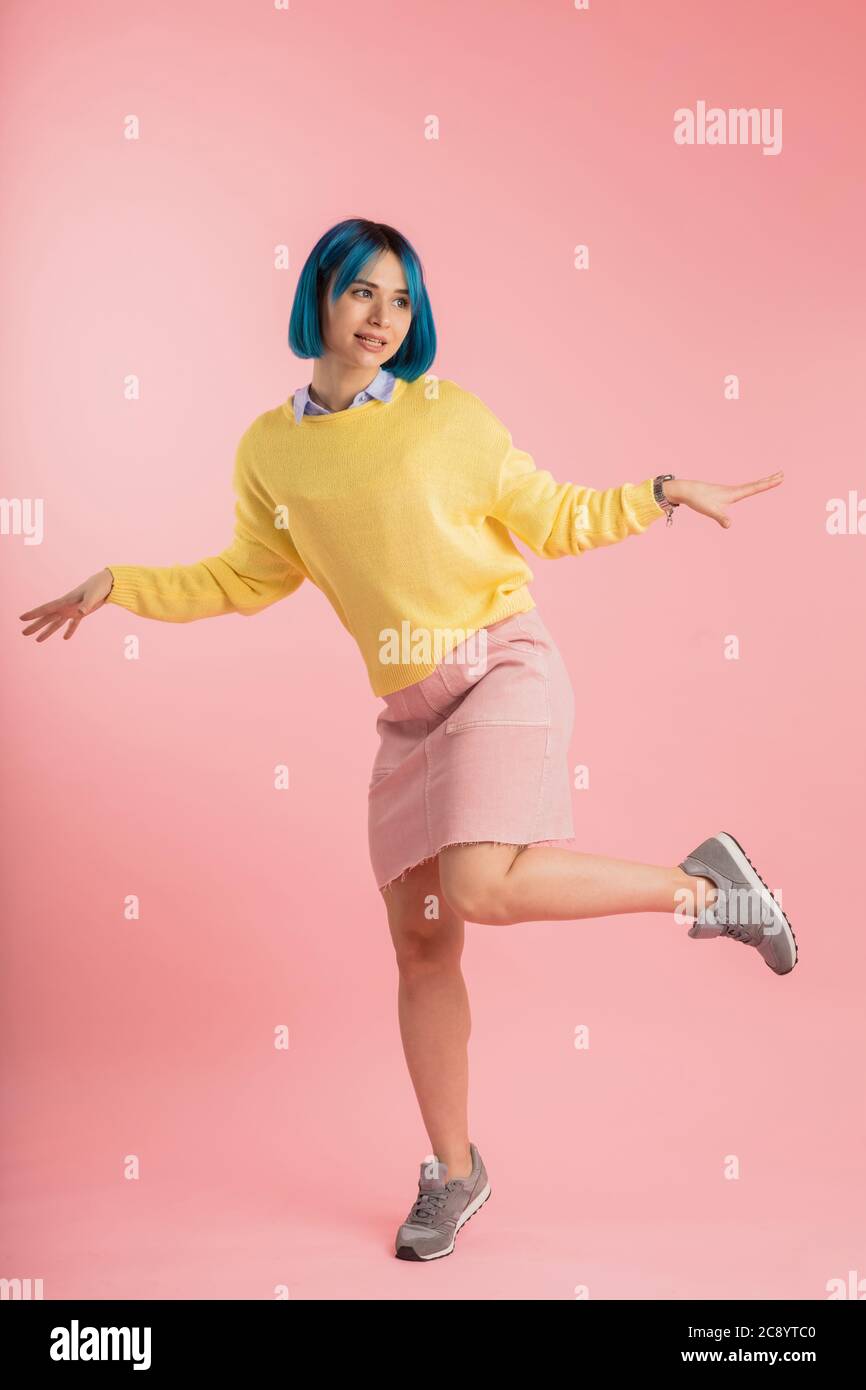 funny girl pretends a bird. full length photo.free time, spare time,awesome girl standing on one