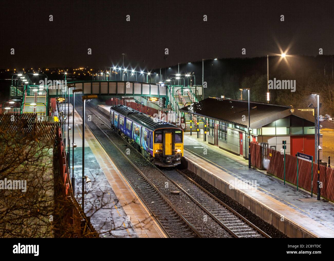 Northern rail / Northern trains class 150 diesel train at Horwich Parkway railway station at night. Stock Photo