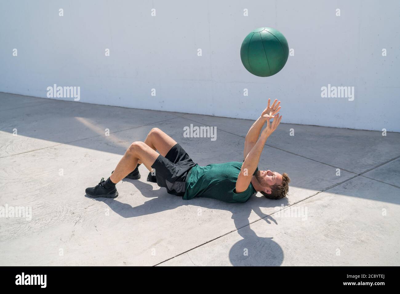 Training man throwing medicine ball in the air Stock Photo Alamy
