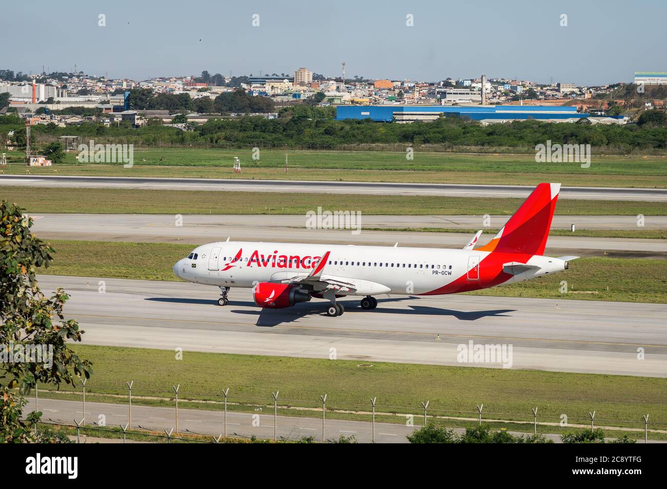 Rear view of Avianca's Airbus A320-200 (PR-OCW) while taxing, heading runway 27R for departure from Sao Paulo/Guarulhos International Airport. Stock Photo