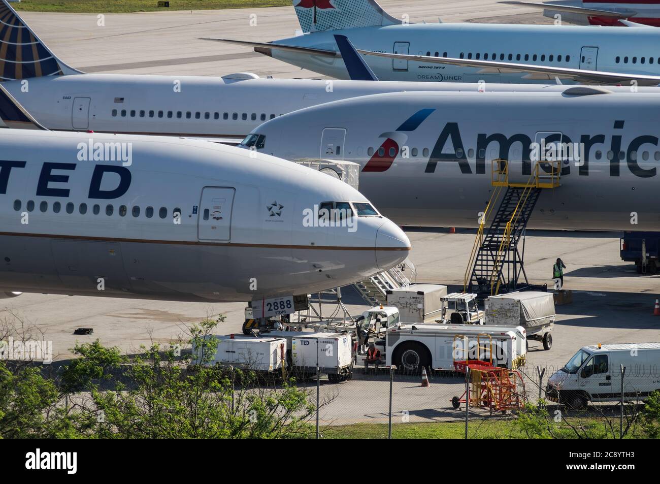 Boeing aircrafts serviced by ground handling equipment while awaiting the next scheduled flight on remote area of Sao Paulo/Guarulhos Intl. Airport. Stock Photo