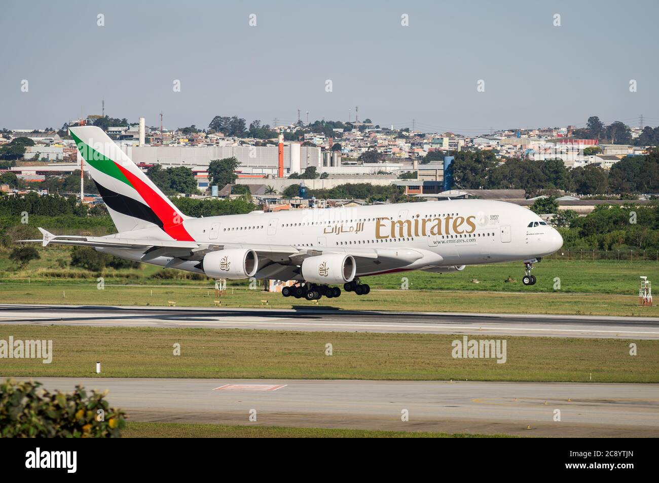 Emirates Airlines Airbus A380-800 (Wide-body aircraft - Reg. A6-EUT) moments before touch the runway 27R of Sao Paulo/Guarulhos International Airport. Stock Photo