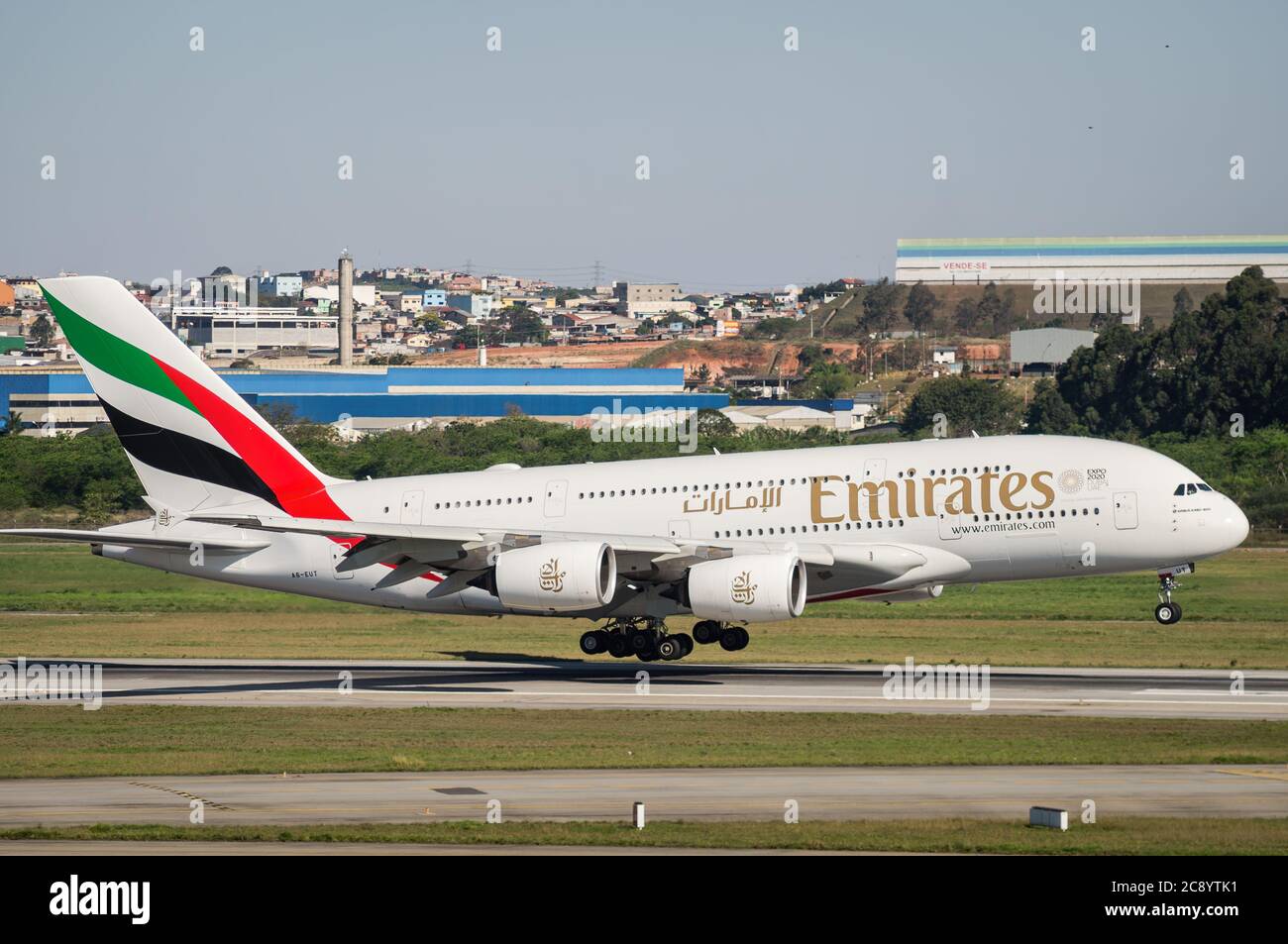 The Emirates Airlines Airbus A380-800 (Wide-body aircraft - Reg. A6-EUT) almost touching down runway 27R of Sao Paulo/Guarulhos International Airport. Stock Photo