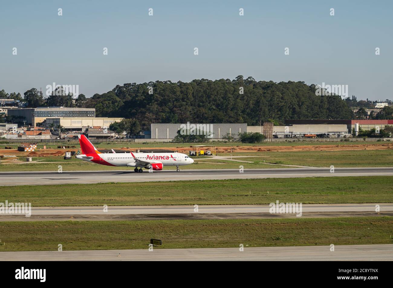 Side view of Avianca's Airbus A320-200 (PR-OCW) during takeoff run on runway 27R of Sao Paulo/Guarulhos International Airport. Stock Photo