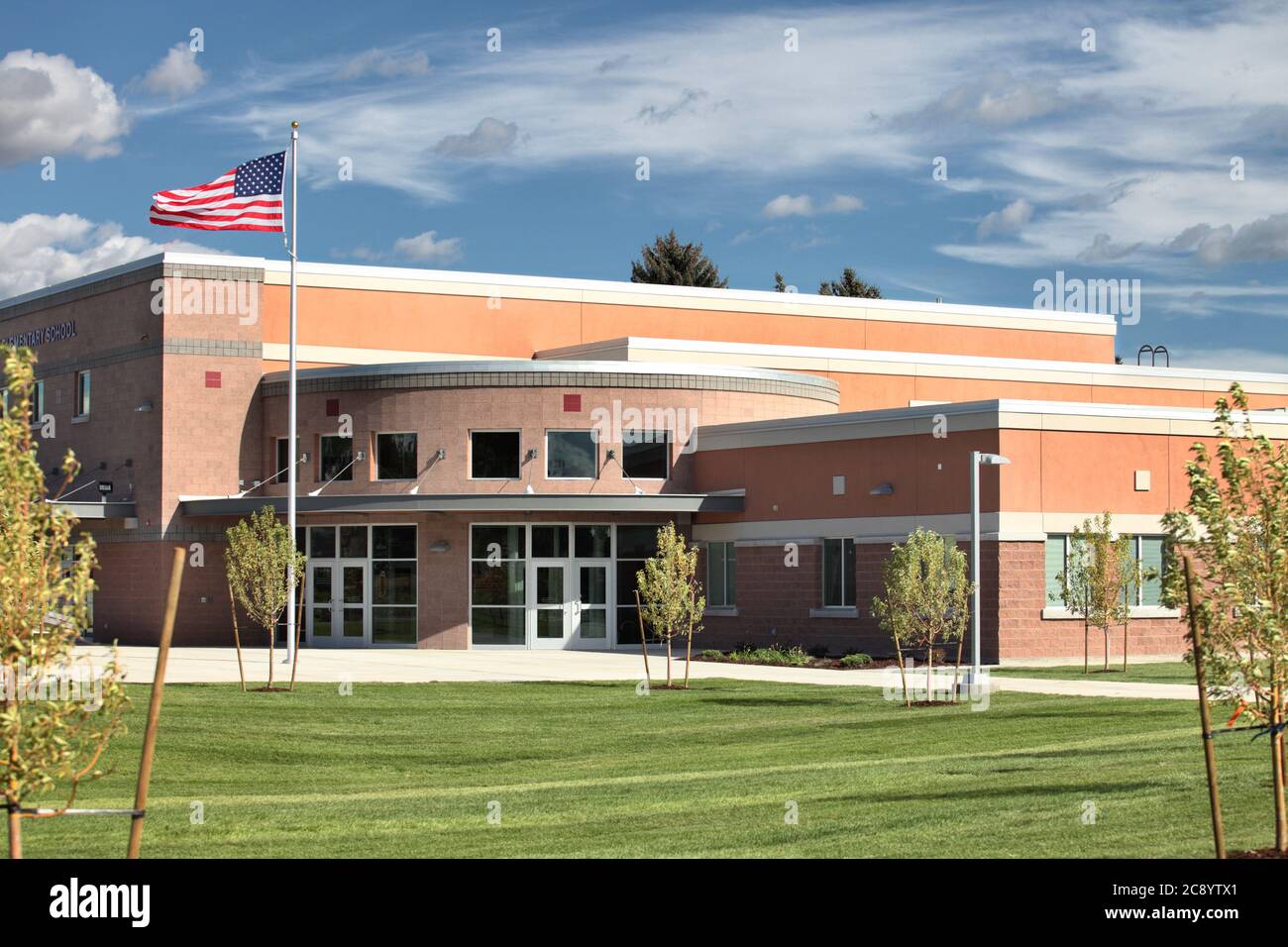 A newly constructed elementary school exterior, with money saving construction, and modern safety features in case of an active shooter scenario. Stock Photo