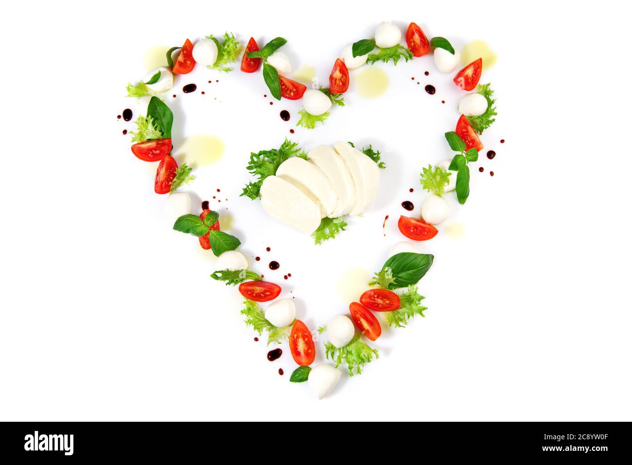 Tomato Mozzarella Heart Shape with Basil isolated on white Background