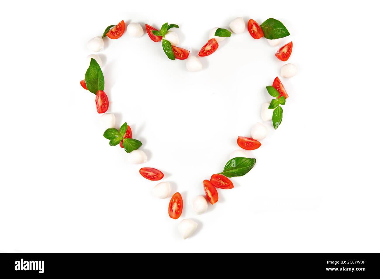 Tomato Mozzarella Heart Shape with Basil isolated on white Background