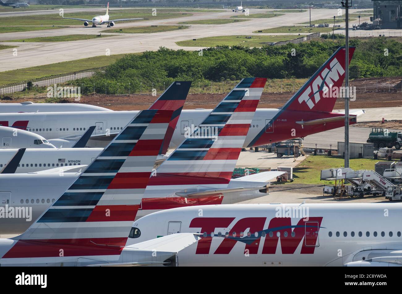 Vertical stabilizers from various aircrafts parked on the remote parking area of Guarulhos Intl. Airport. View from Morrinho spotting location. Stock Photo