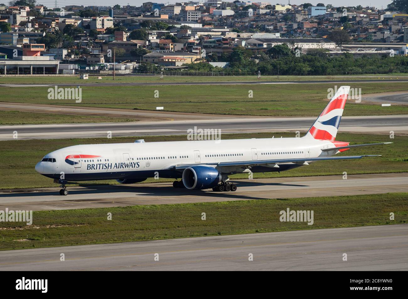 GUARULHOS, SAO PAULO - BRAZIL / SEP 23, 2018: British Airways Boeing 777-336ER (Wide-body aircraft - Reg. G-STBI) taxing heading runway 27R of Sao Pau Stock Photo