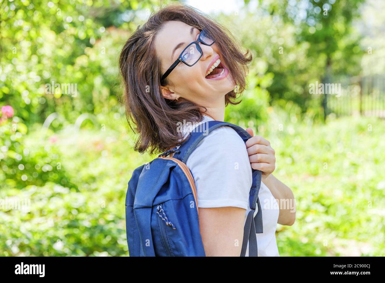 Positive Rested Students Happy beautiful positive student girl in eyeglasses with backpack ...