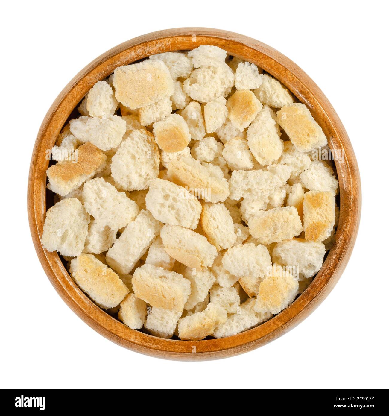 Dry bread cubes for stuffing, in a wooden bowl. Made of rolls, cut into cubes and dried, used for bread stuffing recipes like bread dumplings. Stock Photo