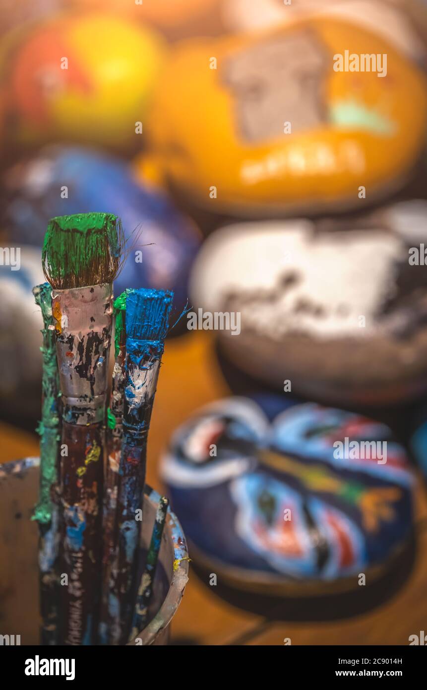 Used paintbrushes with dried paint left standing in a cup Stock Photo