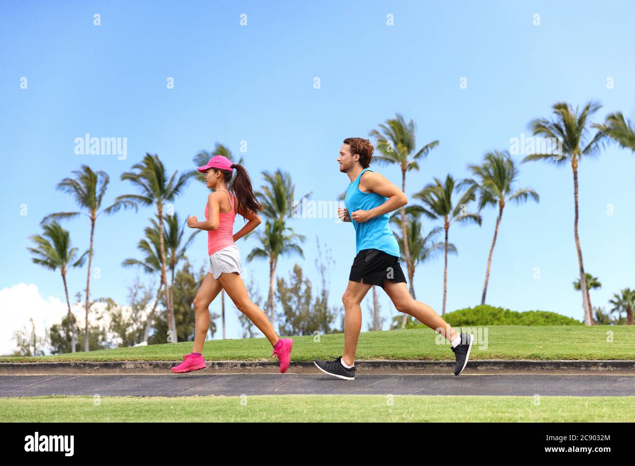Sport fitness couple lifestyle. Healthy people running together in summer park outdoor, runners training cardio Stock Photo