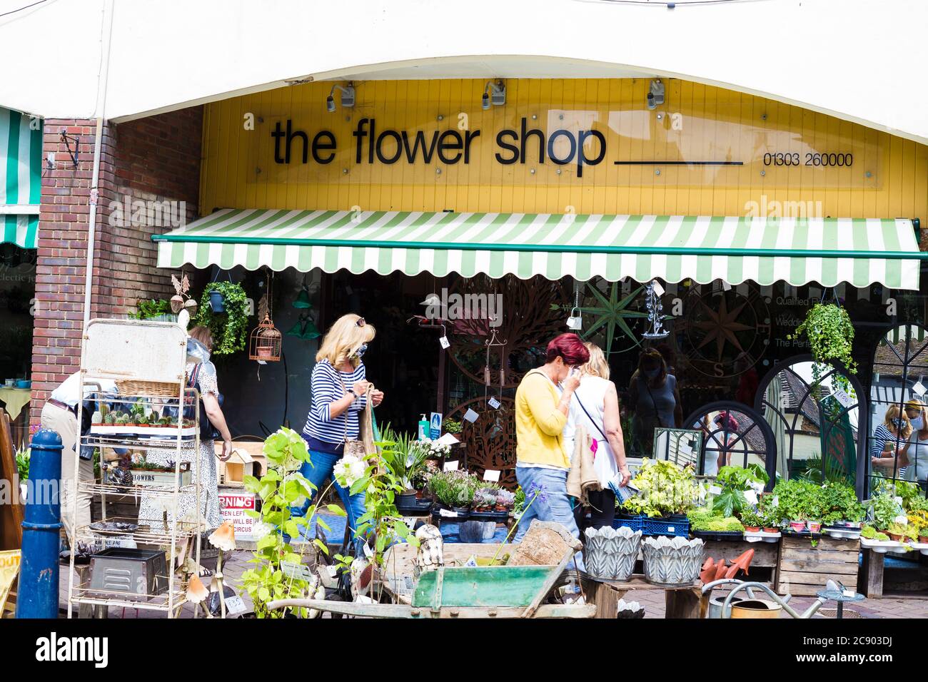 Flower shop in Hythe.Kent. People are browsing the flowers outside the shop. Stock Photo