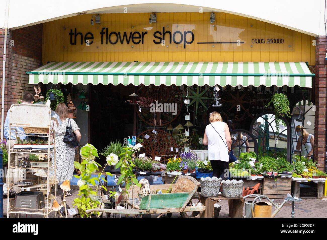 Flower shop in Hythe.Kent. People are browsing the flowers outside the shop. Stock Photo