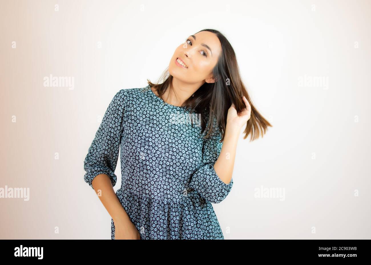 Beautiful woman in blue dress smiling Stock Photo - Alamy