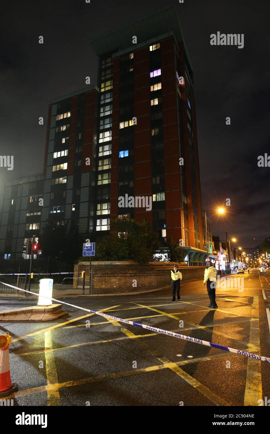 Police cordon at the junction of Chrisp Street and East India Dock Road (A13), Poplar in London