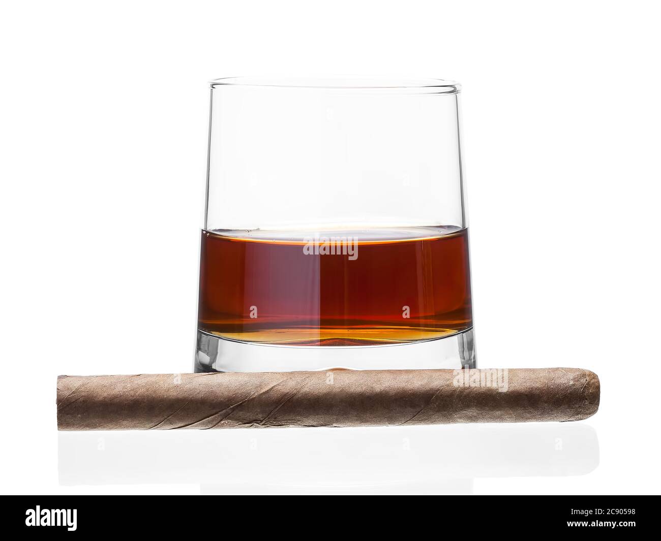 Cigar on a glass of whisky, alcoholic drink with a tobacco product on a white background, nobody