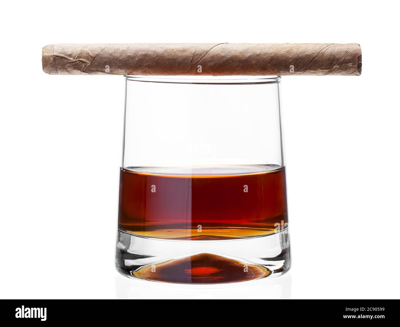 Cigar on a glass of whisky, alcoholic drink with a tobacco product on a white background, nobody