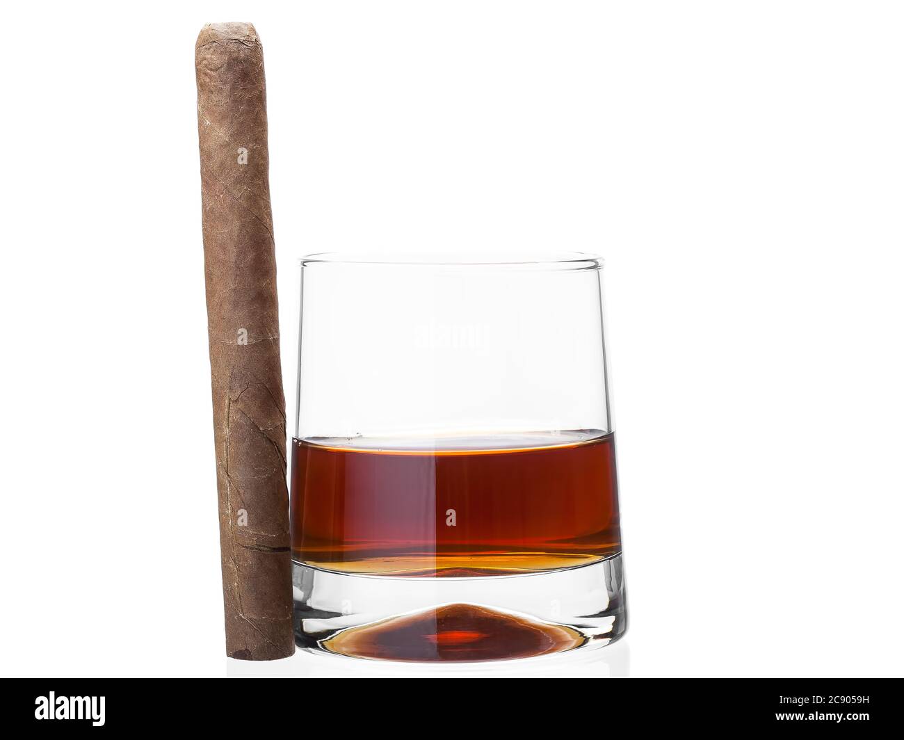 Cigar on a glass of whisky, alcoholic drink with a tobacco product on a white background, nobody