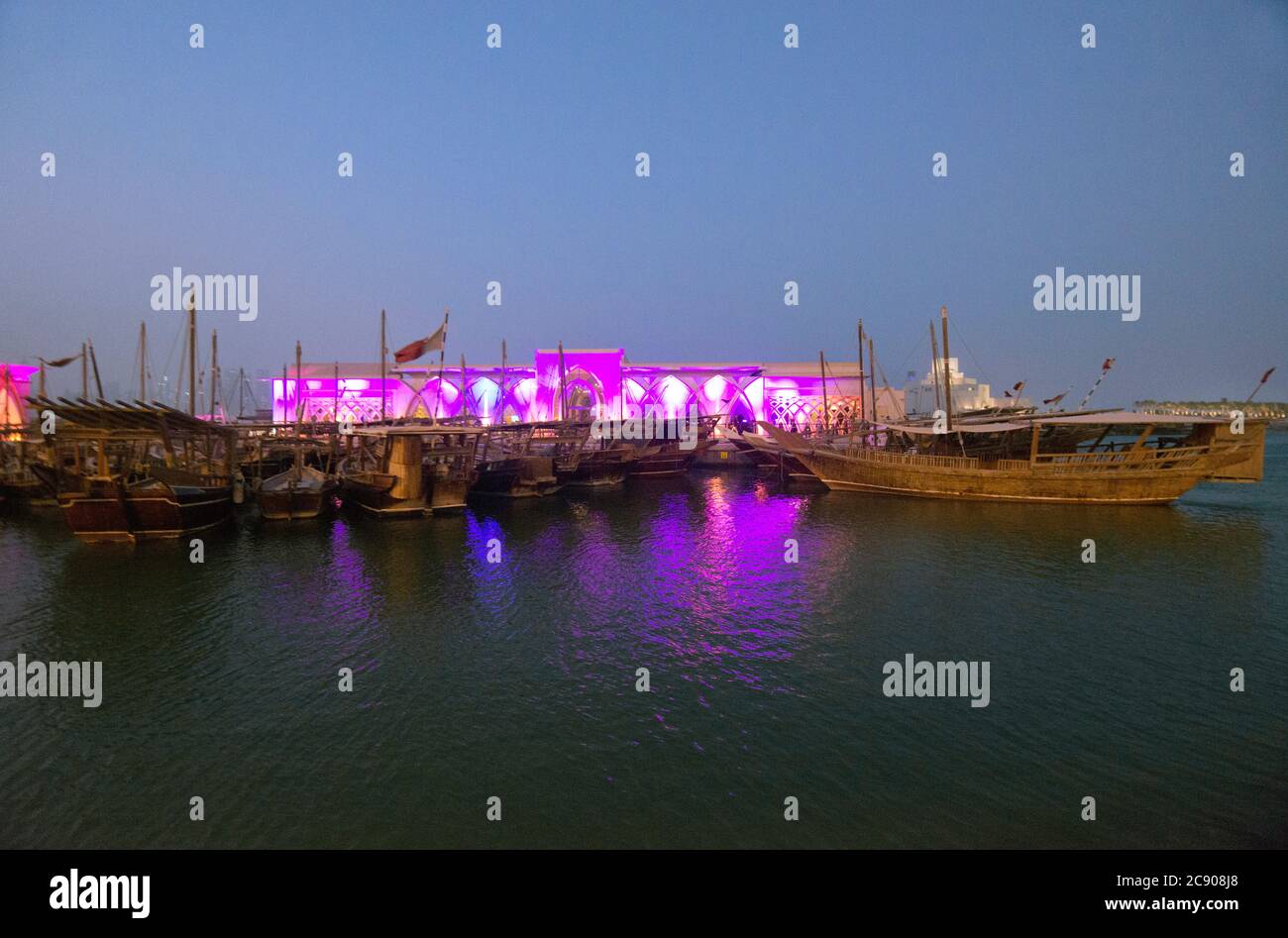 Doha: Dhow harbor and Museum of Islamic Art at twilight. Qatar Stock Photo