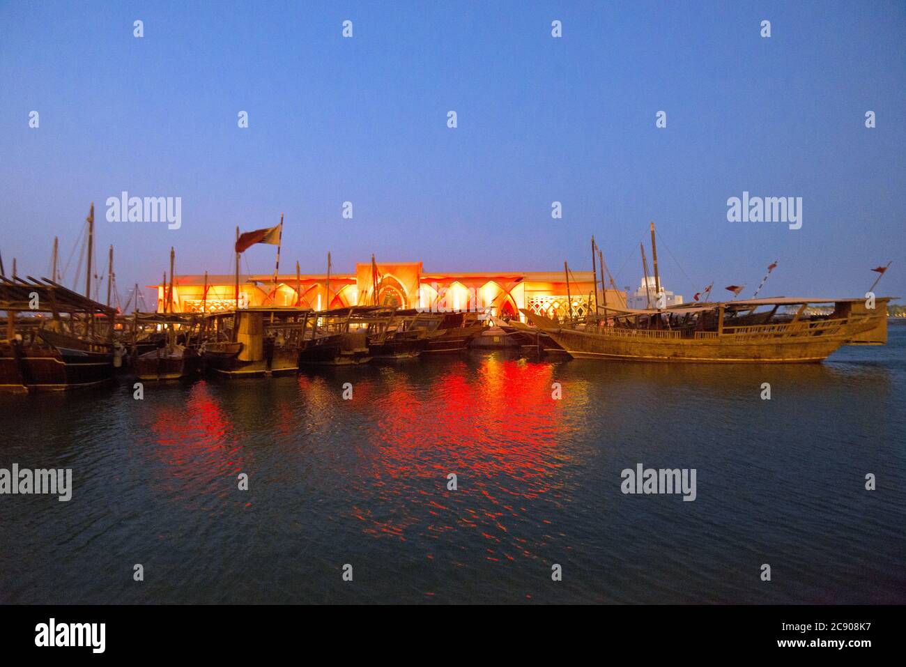Doha: Dhow harbor and Museum of Islamic Art at twilight. Qatar Stock Photo
