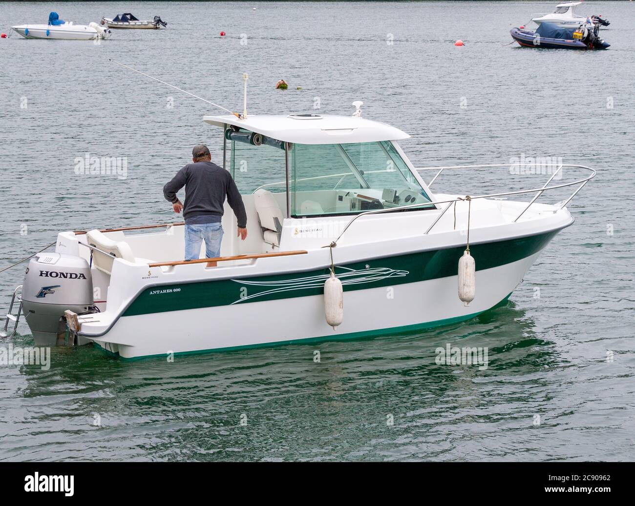 Male 30-50 onboard a Beneteau Antares 600 motor boat. Stock Photo