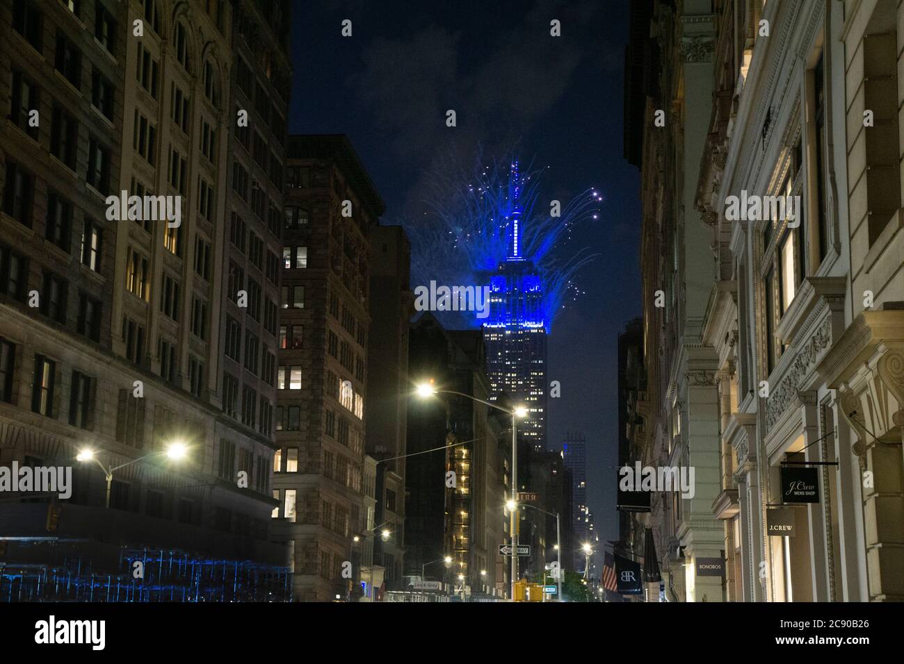 Empire State Building with Blue Fireworks at Night, view from Lower Fifth Avenue, New York City, New York, USA Stock Photo