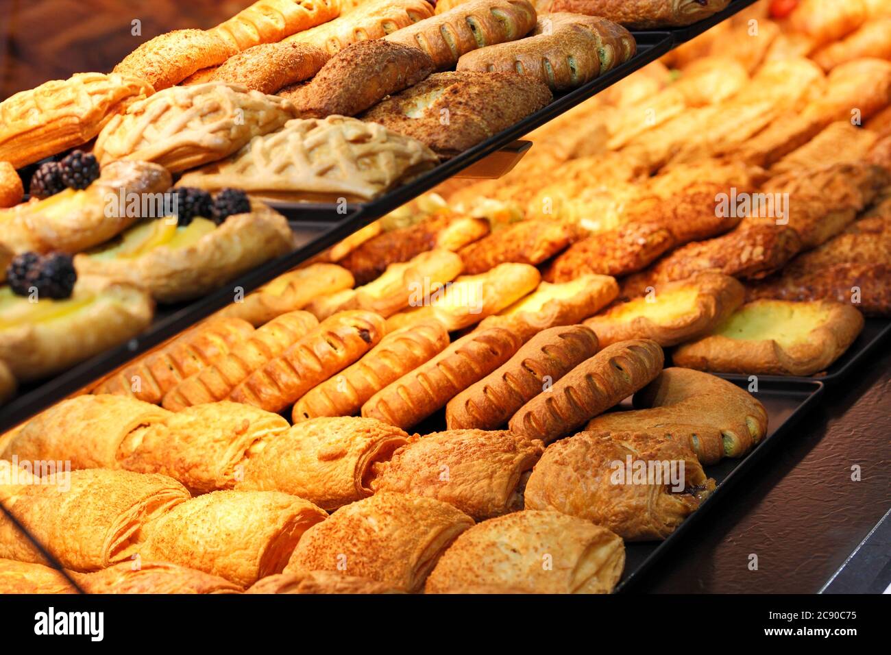 Freshly baked pastries on a bakery shop counter. Selective focus. Stock Photo
