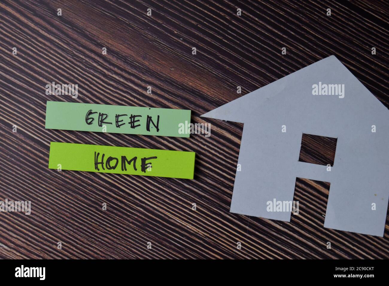 Green Home text write on sticky notes isolated on office desk. Stock Photo