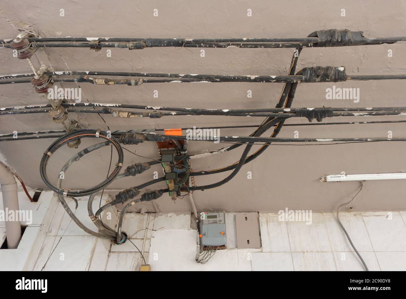 Tapping 3-phase 4-wire power lines run on ceiling of canopy by using  electrical tapes, the cables installed in a pipe run through the wall Stock  Photo - Alamy