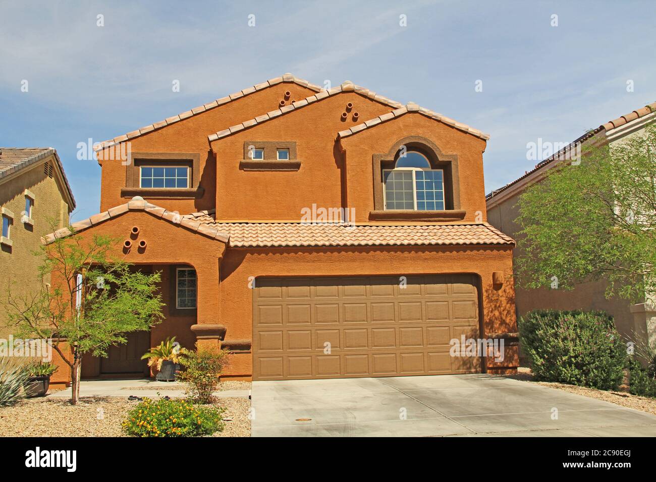 New twostory, brown and terra cotta orange stucco home in Tucson