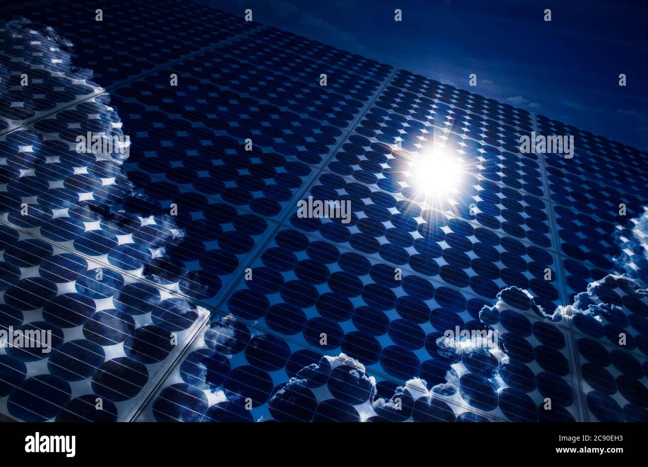 Sun and clouds reflecting in solar panels Stock Photo