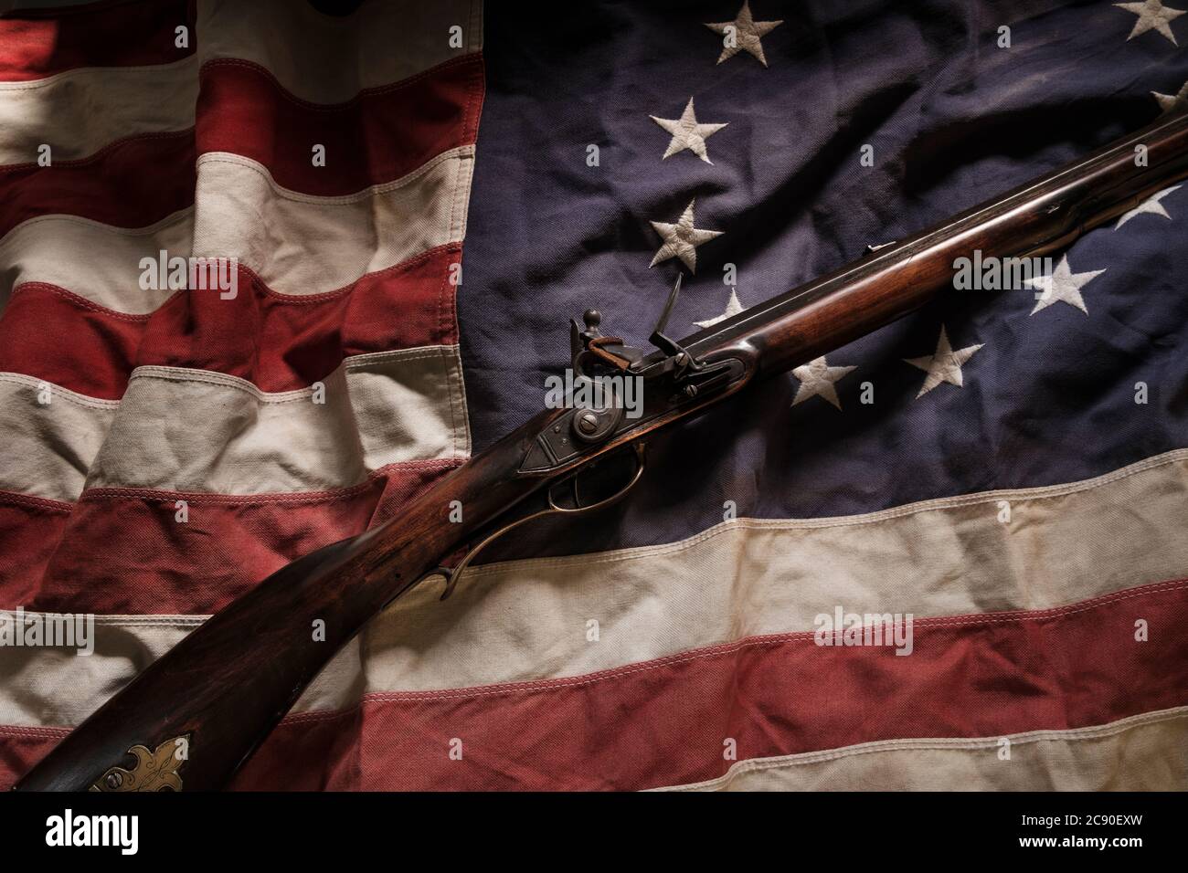Rifle lying on American flag Stock Photo