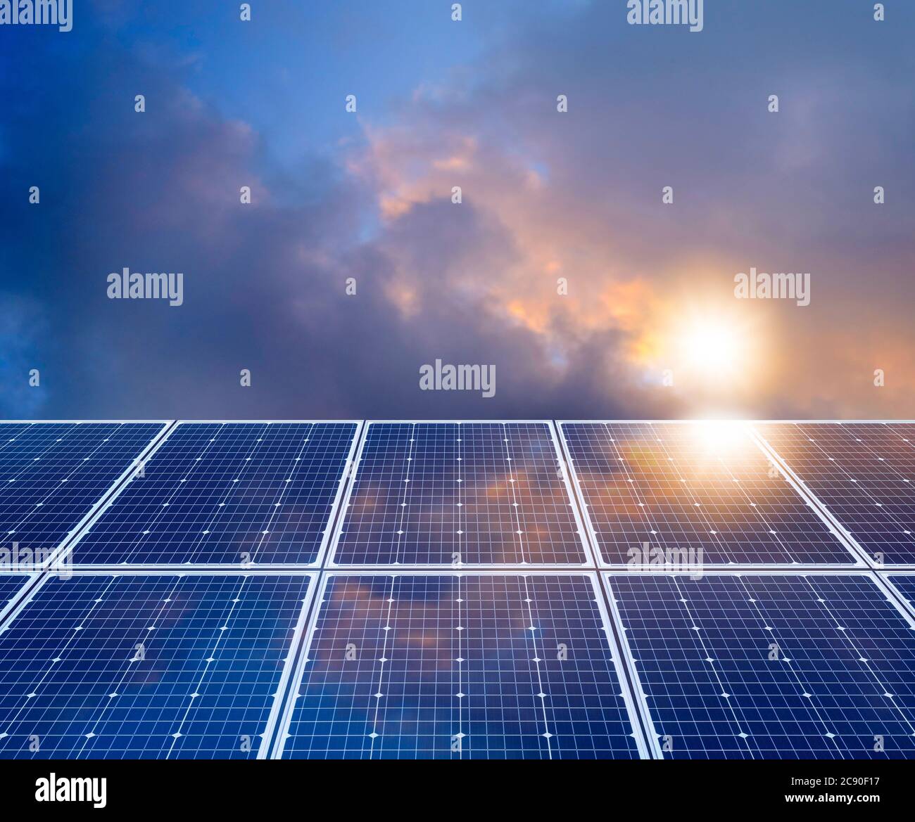 Sun and clouds reflecting in solar panel Stock Photo
