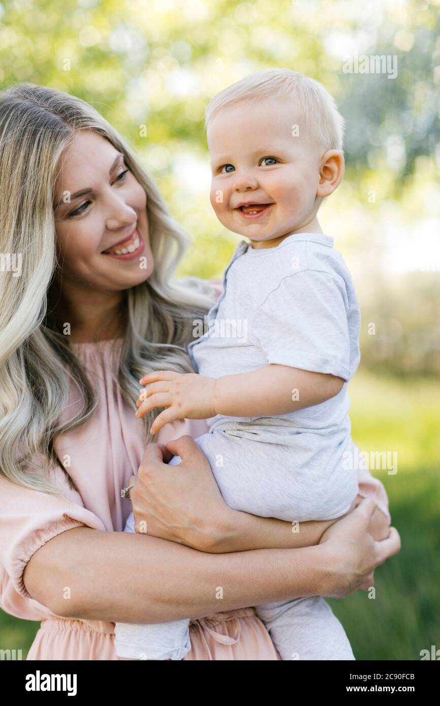 Outdoor portrait of smiling mother and baby son Stock Photo