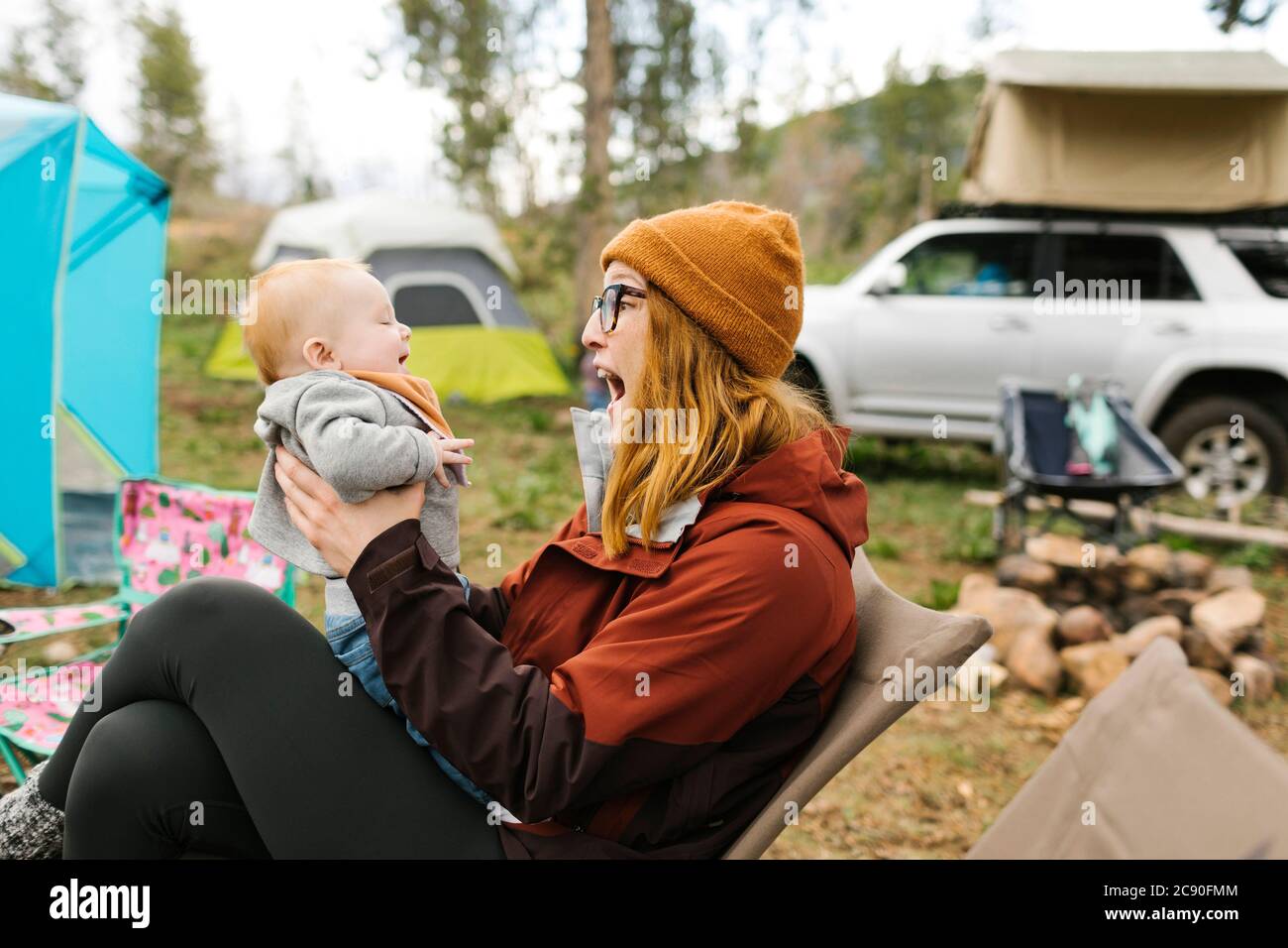 USA, Utah, Uninta Wasatch Cache National Forest, Mother holding son (6-11 months) on campsite Stock Photo