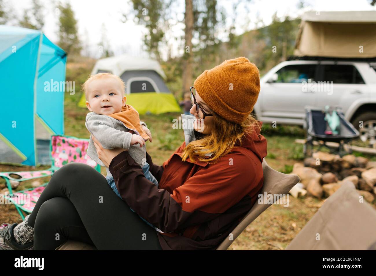 USA, Utah, Uninta Wasatch Cache National Forest, Mother holding son (6-11 months) on campsite Stock Photo
