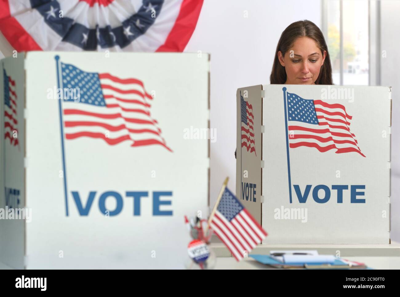 Woman voting in polling place Stock Photo