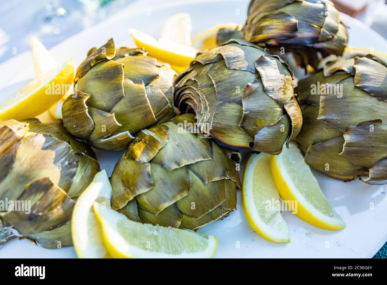 Grilled artichokes with lemon Stock Photo