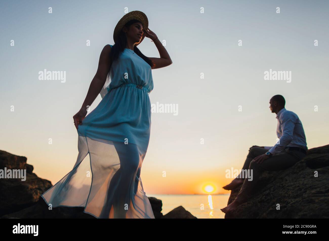 Romantic couple on beach at sunset Stock Photo