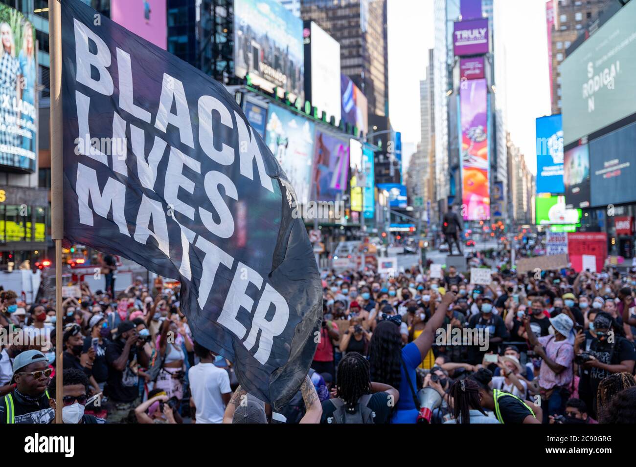 Black Womans/Womxn March Protest - New York City - Black Lives Matter big flag waved in front of nyc protest crowd Stock Photo